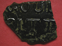 This is a picture of the fragment of bitter bottle. The only letters featured on this fragment are as follows: On the top row we can see the letters G O U and it seems that the last letter is an L. On the bottom row we can see the letters B I T T, which identified this as a fragment of a bitter bottle.